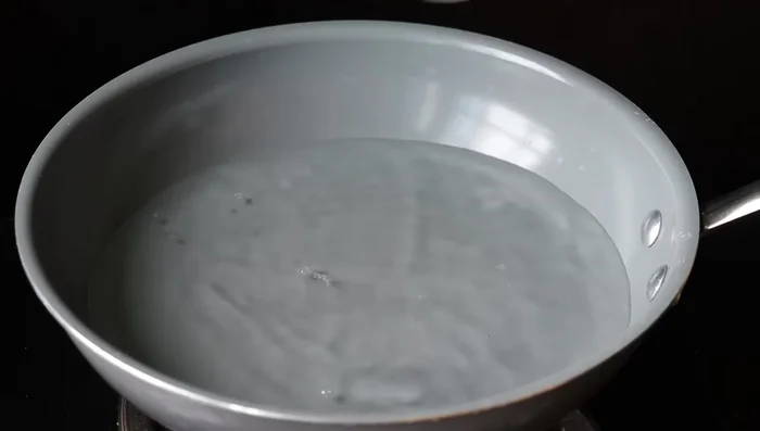 Add the steamed kolukattais to the payasam. Simmer and cook until the kolukattais are well combined in the milk.