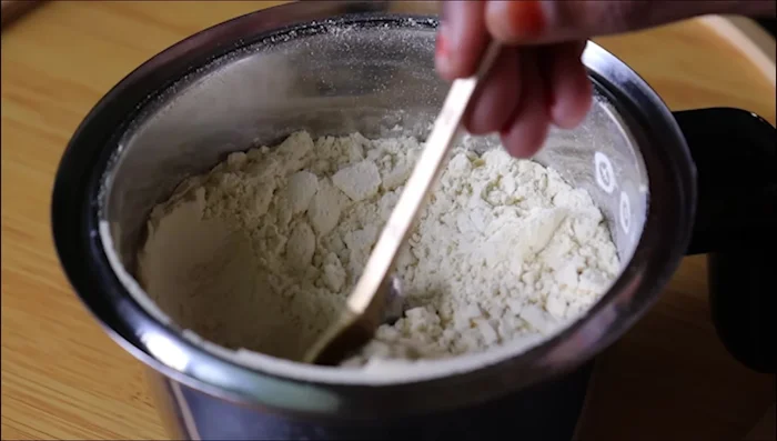 Grind ½ cup cashew nuts and 1 teaspoon cardamom powder into a fine powder using a mixer jar. (52.64)