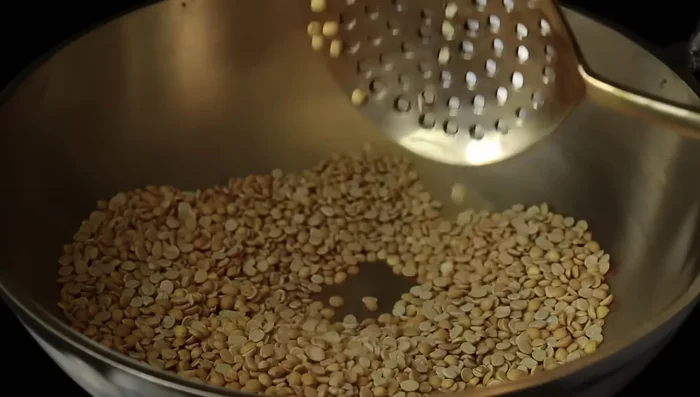 Grind the roasted dals into a coarse powder using a mortar and pestle or a grinder.