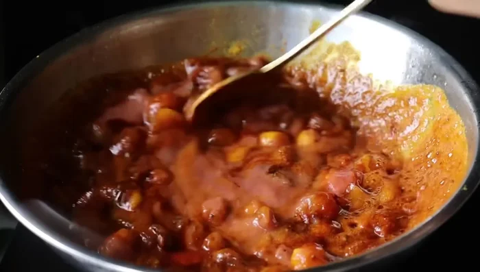 Add finely ground tomatoes and fry until the raw smell disappears.