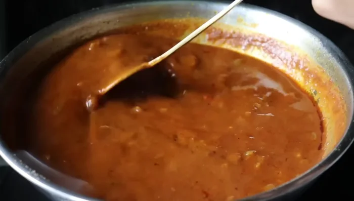 Add jaggery/sugar, mix well, and add black pepper. Simmer until oil separates again.
