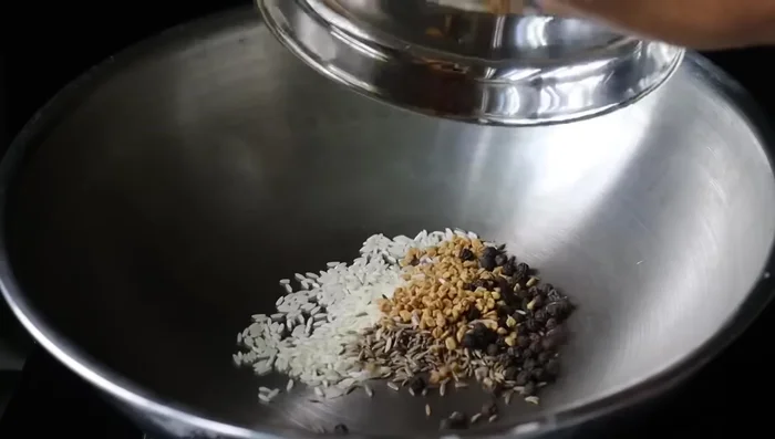 Prepare a powder by dry-frying 1 teaspoon each of pepper, cumin, green chili, 1 teaspoon of fenugreek, and a bunch of washed and dried curry leaves until fragrant.