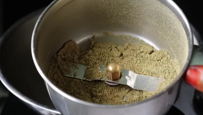 Grind the fried mixture into a fine powder using a mixer jar. Keep aside half of the powder.