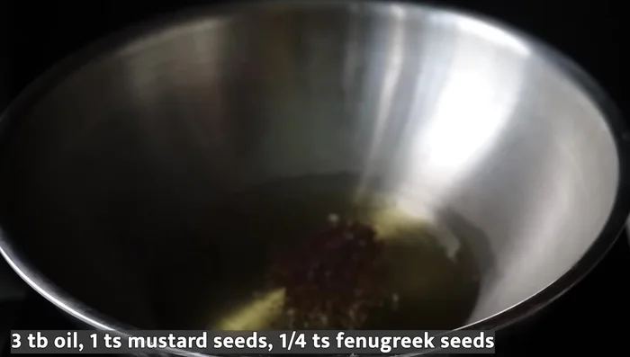 Heat sesame oil in a pan. Add mustard seeds and fry until they splutter. Add 1/4 teaspoon of fenugreek seeds.