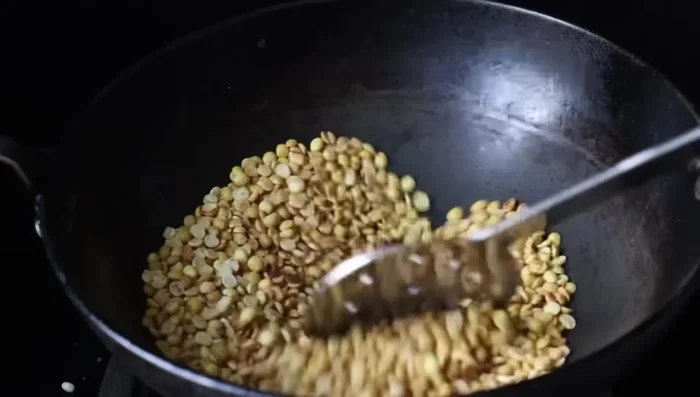Add the fried black gram to the urad dal and chilies mixture.