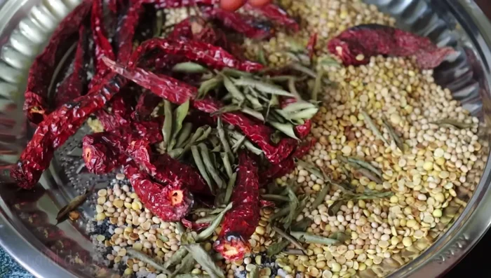 Once cooled, add a handful of dried fenugreek leaves and finely chopped curry leaves.