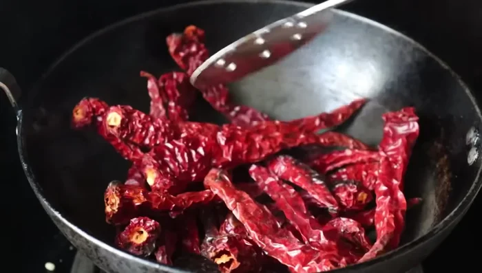 Add the fried chilies to the cooled urad dal.