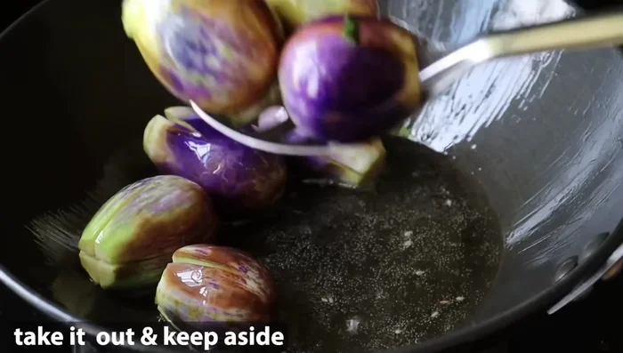 Add water and cook until the brinjal is tender and the gravy has thickened.