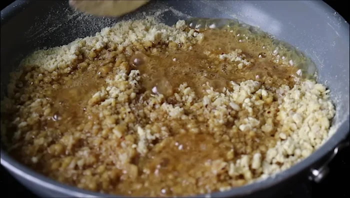 Place a spoonful of pooranam filling in the center of each dough ball.