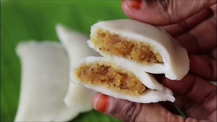 Prepare the pooranam filling by combining jaggery, grated coconut, and cardamom.