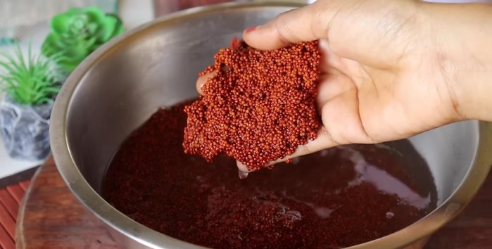Strain the soaked ragi and grind it into a fine paste in a mixer jar, adding water gradually.