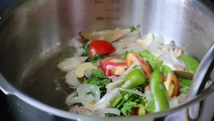 Simmer, stirring occasionally, until the coconut milk is absorbed and the rice is well-cooked and creamy. (Details missing in transcript)