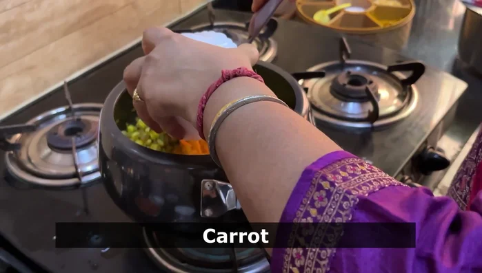 Add sweet corn, grated carrot, chopped tomatoes, green chilies, whole pepper, salt, and coriander leaves.