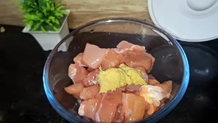 Add ginger-garlic paste, red chili powder, garam masala, black pepper, chicken tikka masala, chaat masala, and kasuri methi to the chicken. Mix well.