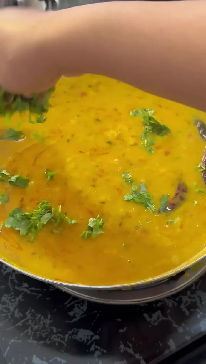Add the boiled lentils to the spiced mixture and stir well. Let it boil.