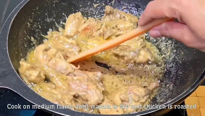Increase the heat slightly and fry the chicken until golden brown and the masala coats it well.