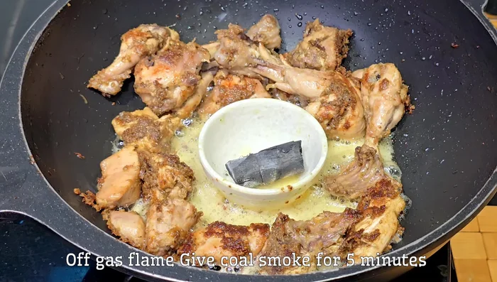 Heat coal on high flame for 5 minutes and add it to the chicken, covering the pan for 5 minutes to enhance flavor.