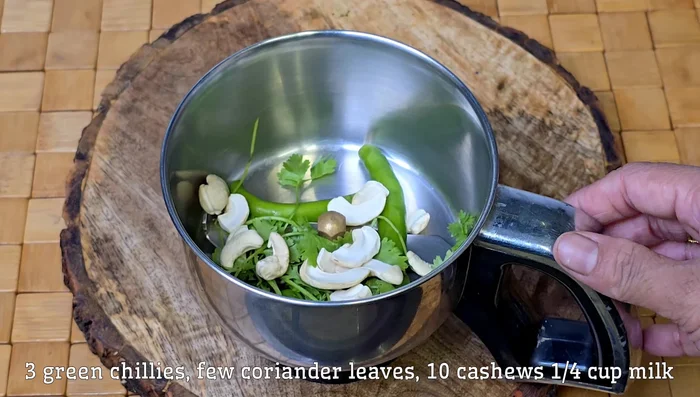 In a bowl, mix chicken with ginger, garlic, green chilies, green coriander, cashews, milk, roasted cumin, garam masala, chaat masala, black pepper powder, dried coriander powder, salt, curd, and lemon juice.