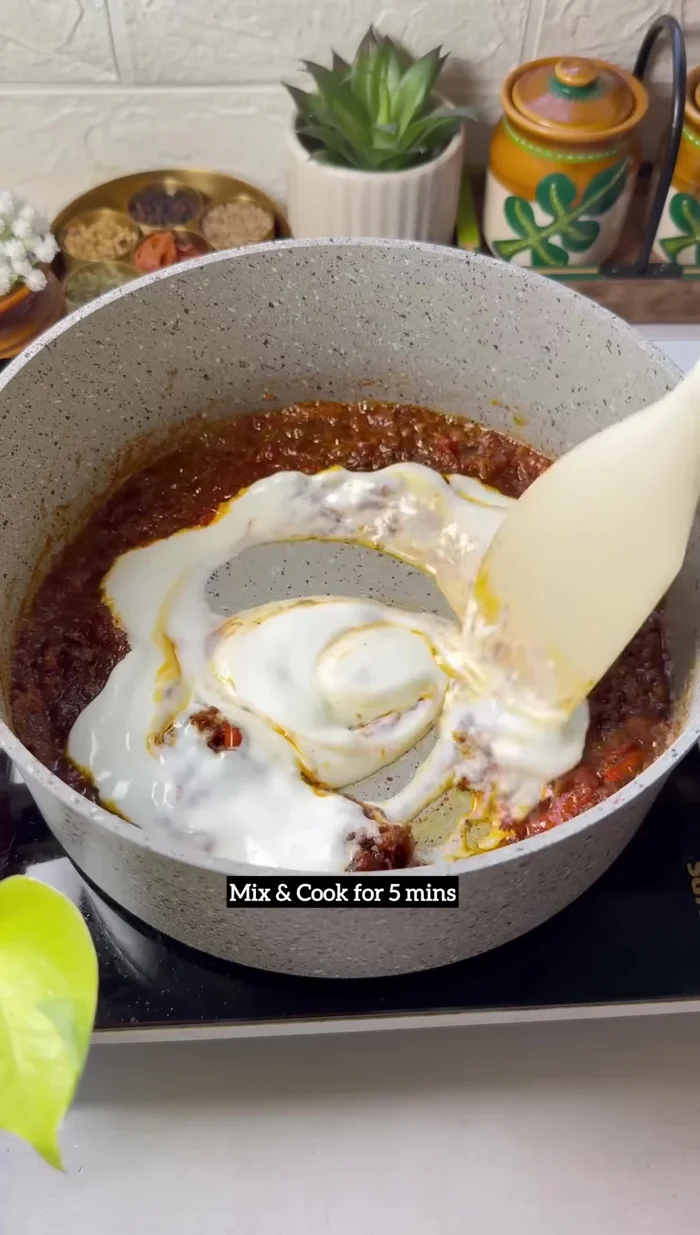 Add curd: Reduce heat to very low, add curd, and cook for 5 minutes, stirring gently.