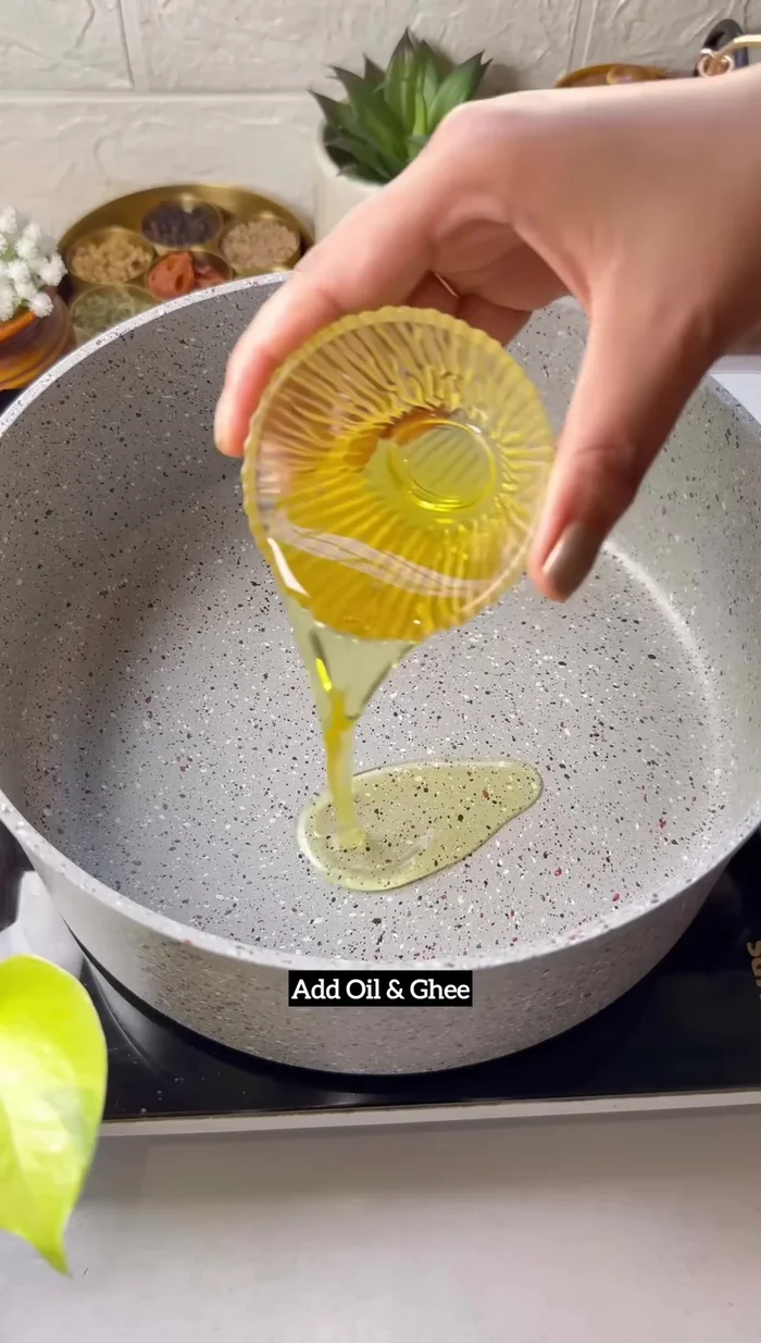 Sauté aromatics: Heat oil and ghee in a pot. Add fried onions, crushed ginger, garlic chilli paste, tomato, and salt. Cook tomatoes for 5 minutes.