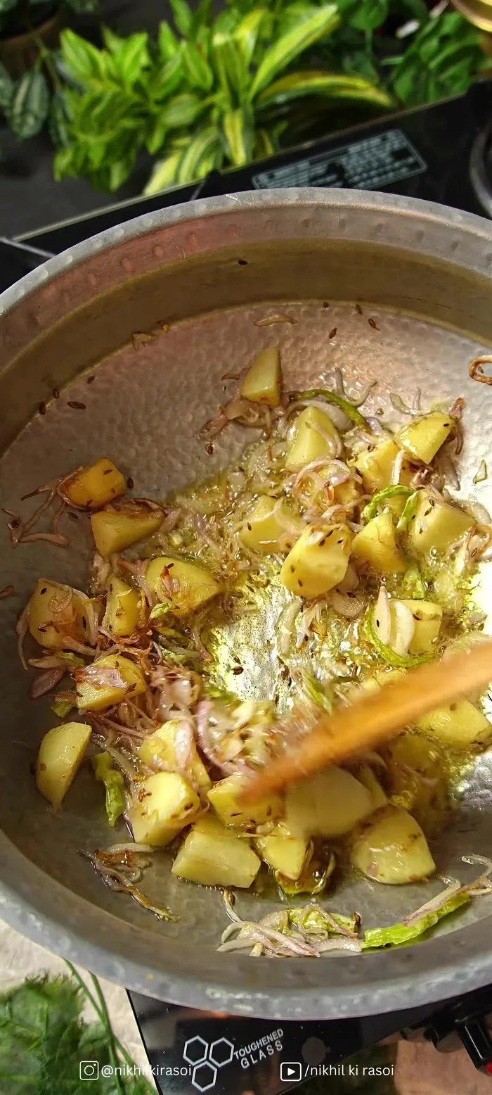 Add tomato puree and cook. Then add turmeric, red chili powder, coriander powder, pomegranate powder, cumin powder, and fry well.