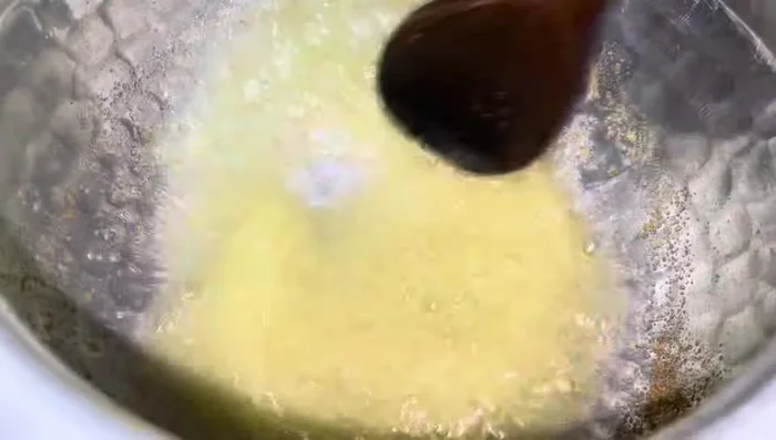Include the garam masala and salt. Saute for a bit, then add water and bring to a boil.