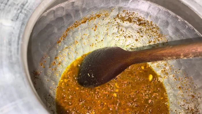 Add the soaked lentils to the pan, stirring well. Cook until the lentils are soft and the water has mostly evaporated.