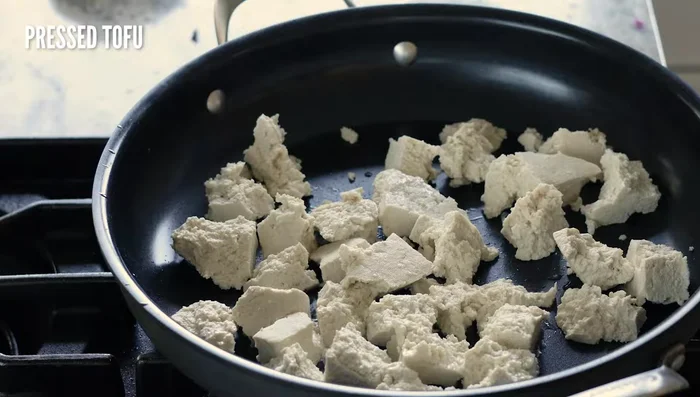 Crisp the tofu: Heat oil in a skillet over medium-high heat. Add tofu, garam masala, and cinnamon. Cook undisturbed for 2-3 minutes per side, flipping to crisp all edges. Remove from skillet.