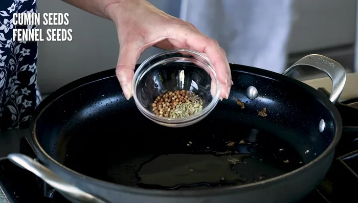 Sauté aromatics: Reduce heat to medium. Add oil, cumin, fennel, and coriander seeds. Cook for 30 seconds. Add onion and salt; cook until golden, adding splashes of water to prevent burning.