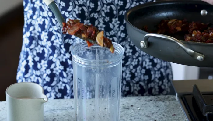 Blend the sauce: Let the tomato mixture cool slightly. Blend in batches with non-dairy milk until smooth. Blend multiple times to ensure seeds are finely incorporated. Let sit 5 minutes, then blend again.