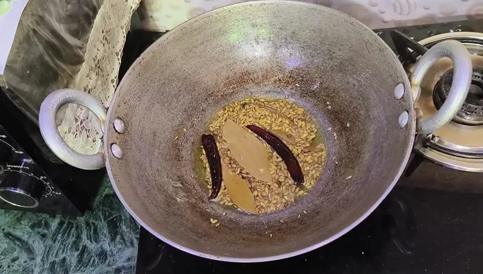 Add finely chopped ginger and green chilies. Cook for 2 minutes.
