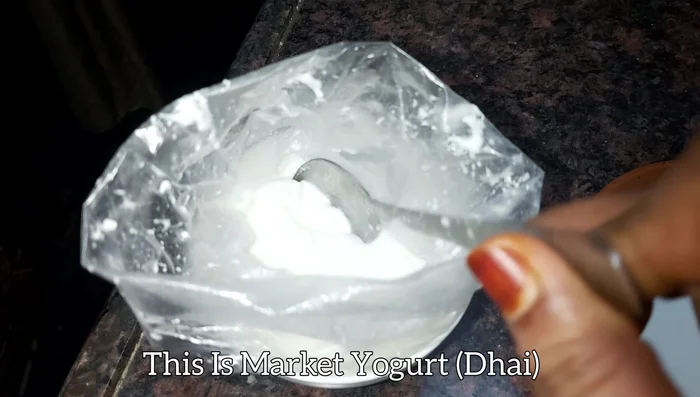 Add two tablespoons of market yogurt to the warm milk.
