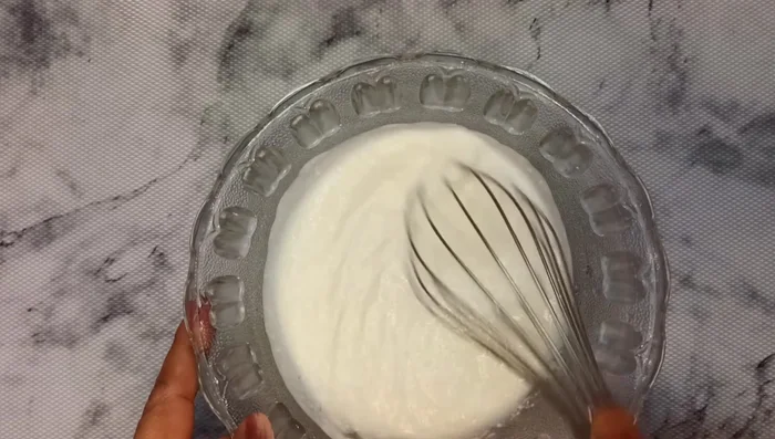 Beat the curd well until smooth. Add 1/4 cup water and beat until fluffy.