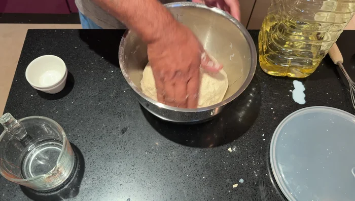 Knead the dough for 2-3 minutes. Add oil, seal it in an airtight container, and let it rest for 10 minutes.