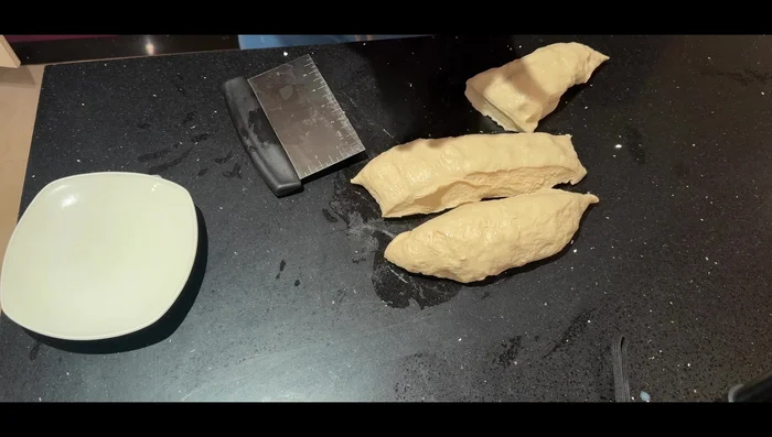 Make dough balls (approx. 200g each). Cover with a damp cloth and let rest for another 10 minutes.