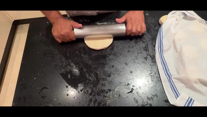 Roll out each dough ball into a large circle (9-10 inches).