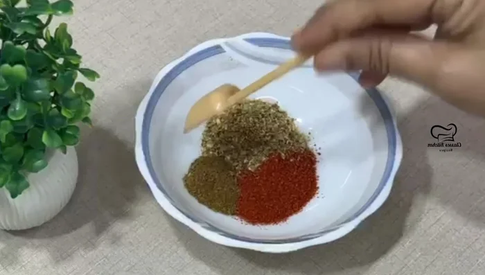 Prepare the masala for marinating the brinjal: In a bowl, mix Kashmiri red chili powder, coriander powder, cumin powder, mango powder, turmeric powder, and salt. Mix well. (56.8)