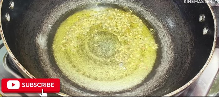 After the cumin seeds crackle, add the thinly sliced onions. Fry the onions for 1 minute.