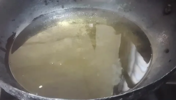 Add karapusa dough balls to hot oil. Press gently after they float.