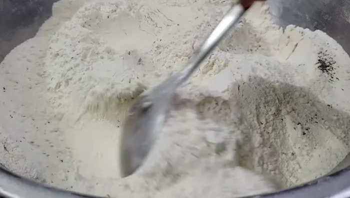 Add turmeric powder, chili powder, and salt. Mix well.