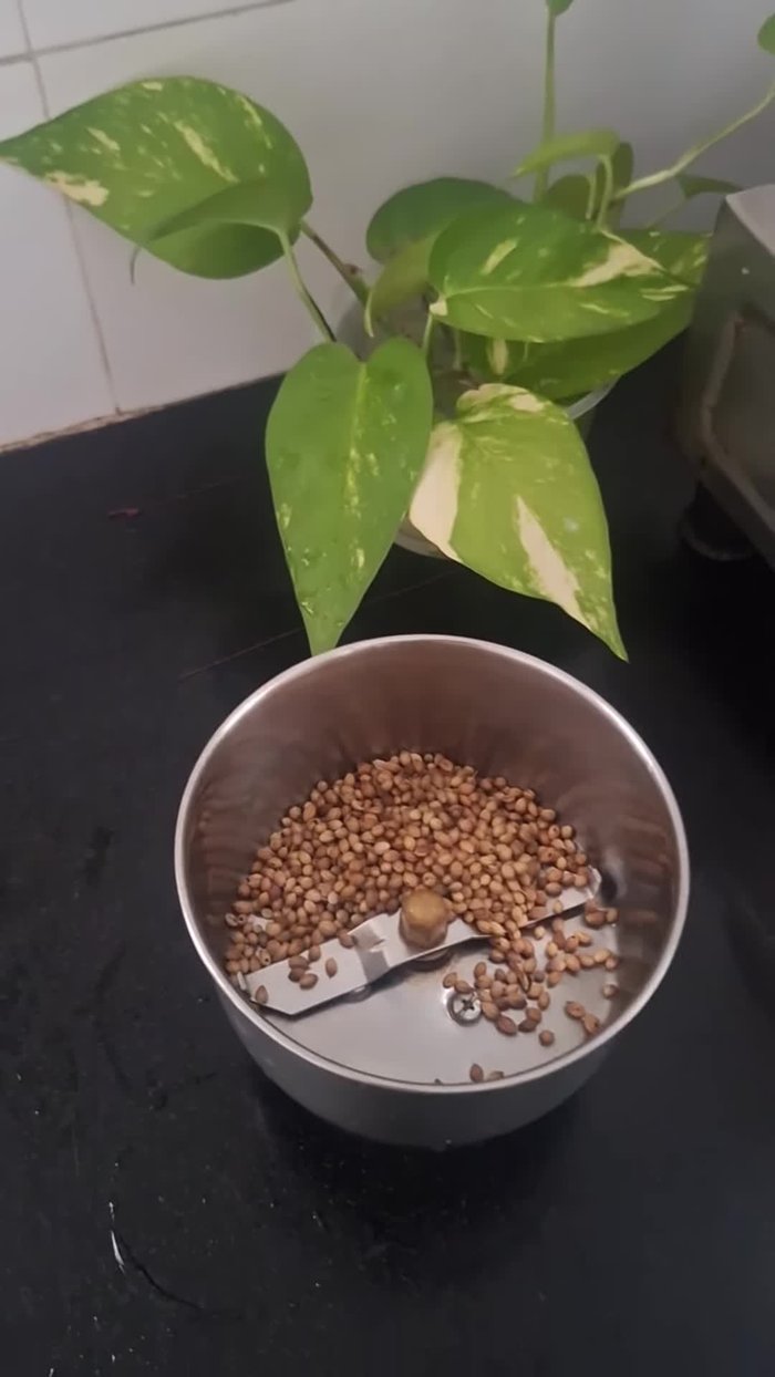 Grind ginger, garlic, green chilies, and coriander leaves into a paste.