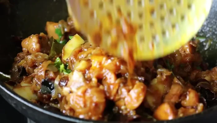 Cut the chicken into small pieces, garnish with coriander leaves, and serve.