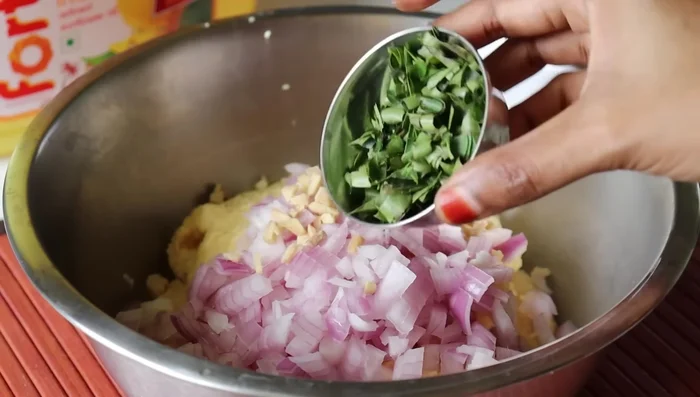 Divide batter in half. To one half, add chopped onion, grated ginger, coriander leaves, green chilies, salt, anise, and rice flour. Mix well.