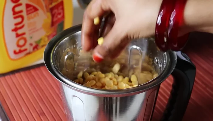 Drain soaked peas and urad dal, then blend until a thick batter forms. Don't add too much water.