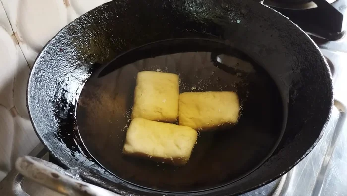Deep fry the Goja pieces in cold oil over low heat until golden brown. This will take approximately 6-7 minutes per batch.