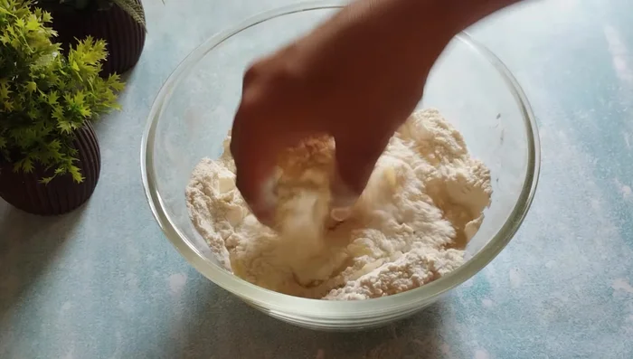 Add oil (or ghee) to the flour mixture and mix roughly until crumbly.