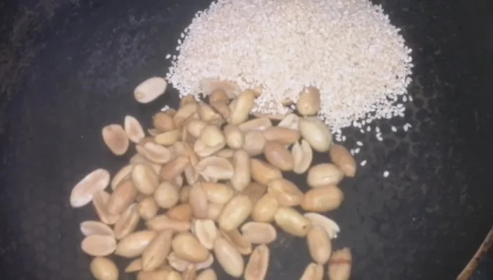 Roast peanuts, sesame seeds, fenugreek seeds, cashews, and coconut powder in a pan over low heat until fragrant and lightly roasted. (107.799)