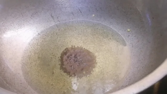 In the same pan, add mustard seeds, cumin seeds, and nigella seeds. Once they crackle, add curry leaves. (255.36)