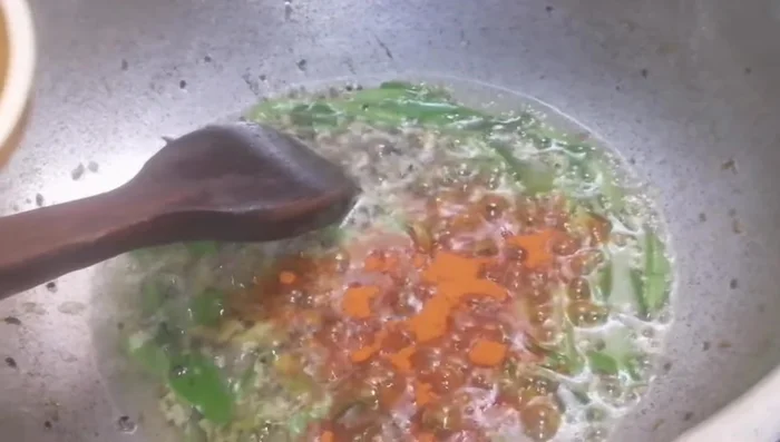 Add ground red chili, turmeric powder, and roasted crushed coriander. Sauté until fragrant. (305.04)