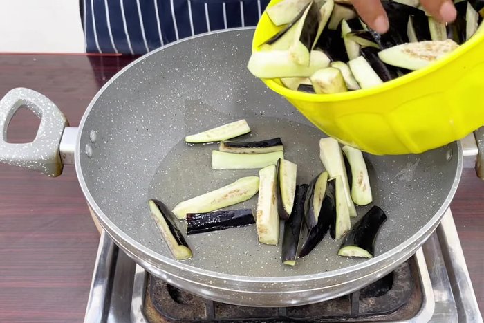 Fry the brinjals for 4-5 minutes on medium-low flame until the color of the skin changes slightly.